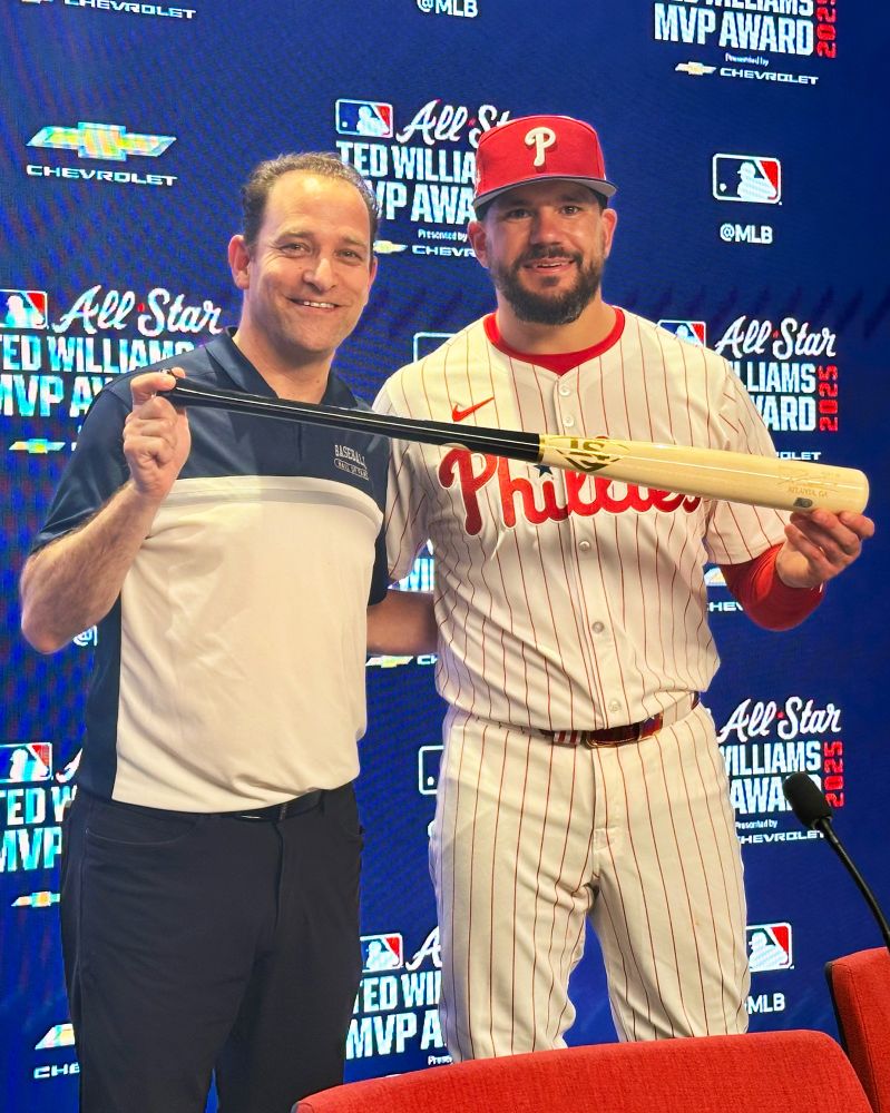 Hall of Fame President Josh Rawitch poses with Kyle Schwarber and his bat.