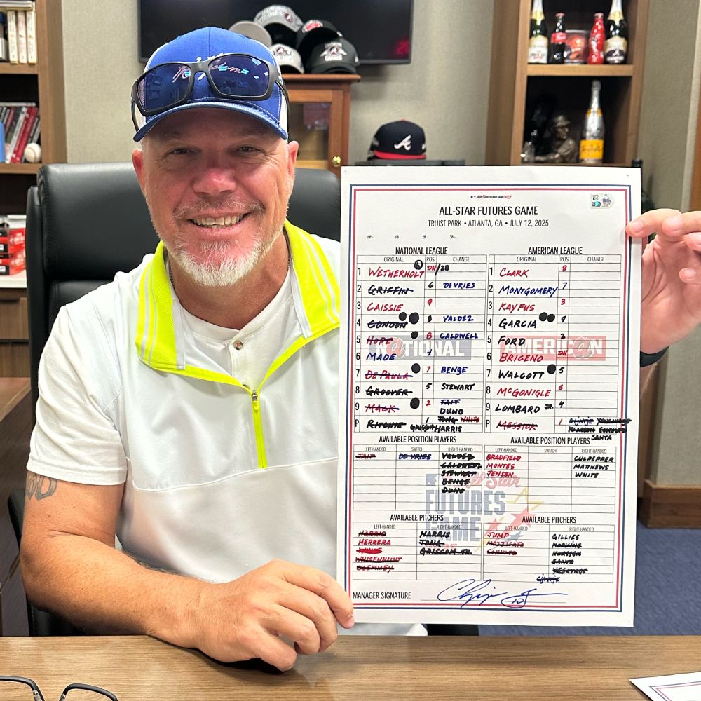 Chipper Jones, manager of the National League team in the 2025 All-Star Futures Game, poses with his signed lineup card.