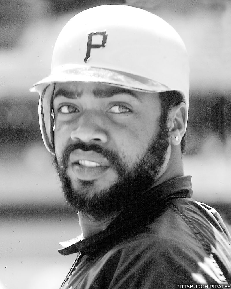 Black and white head and shoulders portrait of Dave Parker in a Pirates helmet. (Photo courtesy Pittsburgh Pirates)