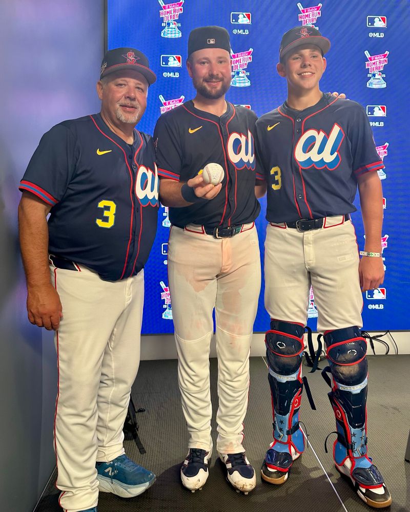 From left, Todd Raleigh Sr., Cal Raleigh and Todd Raleigh Jr. pose with a signed baseball after the 2025 Home Run Derby.