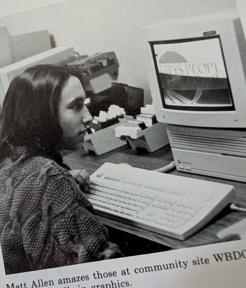 A picture of me at 17 years old in 1989 using a very old Apple Mac and one of the first (if not first) versions of Adobe illustrator in 1989. There are floppy disks. 