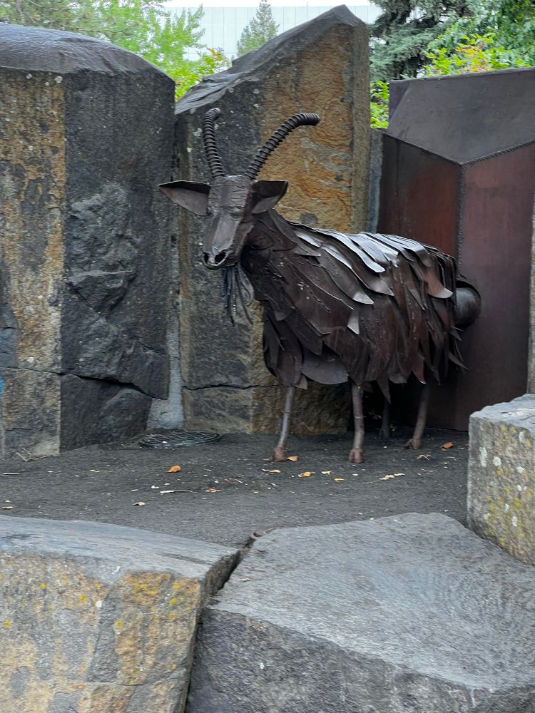 A metal statue of a goat lovingly dubbed Garbage Goat. There’s a button behind him that if you push it he’ll suck up your trash
