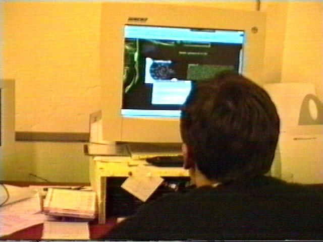 A young game developer in front of a screen.