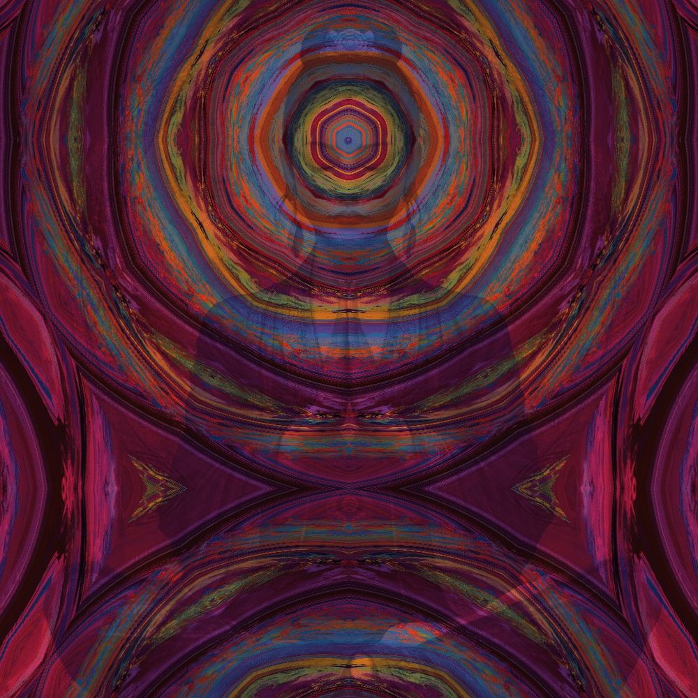 A woman sits in a meditation pose with her hands pushed together over her heart. Her eyes are closed and a kaleidoscope of colorful patterns and colors emanates from her third eye rippling out and then the colors return toward her root chakra.