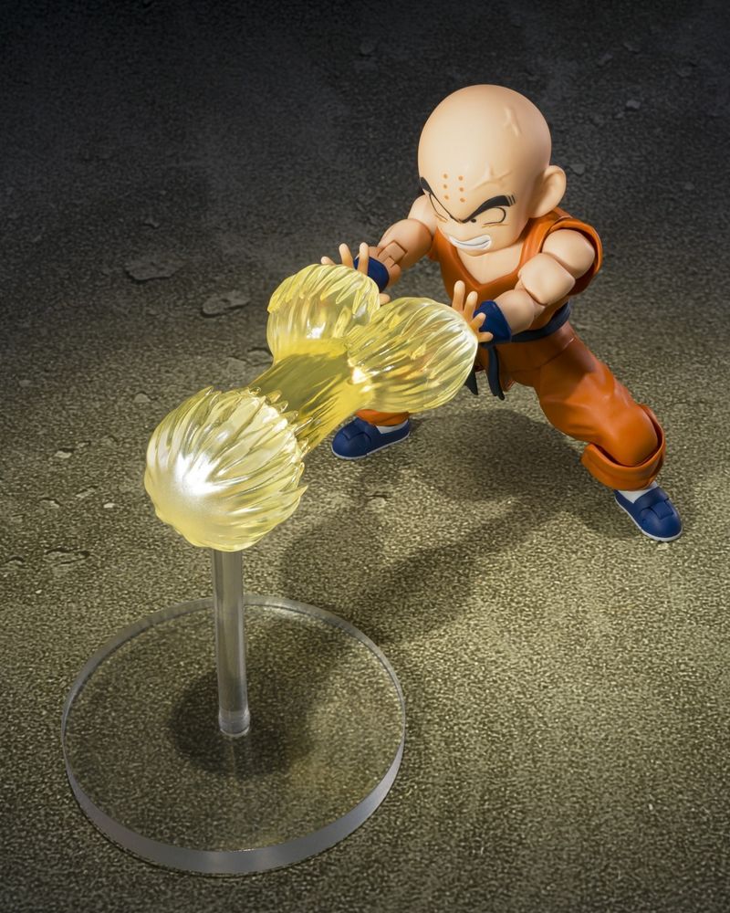 An image of a new pose-able figure of Krillin from Dragon Ball Z. In its shown configuration, he has both arms extended straight in front of his body. He is firing a Ki-blast from each hand that joins together to form a single beam. There is an unmistakable likeness to a dick and two testicles.