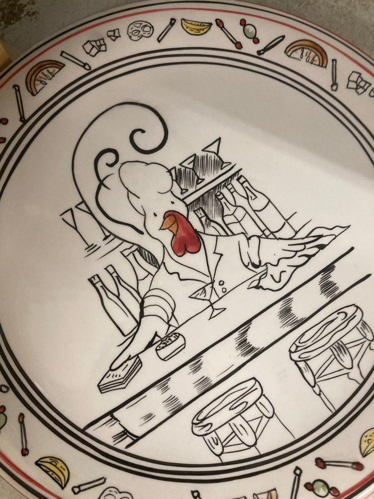 A plate with a chicken bartender behind a bar on it.