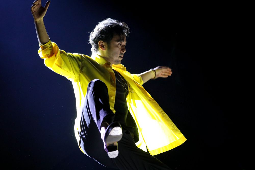 Tap dancer Kazunori Kumagai with his leg raised