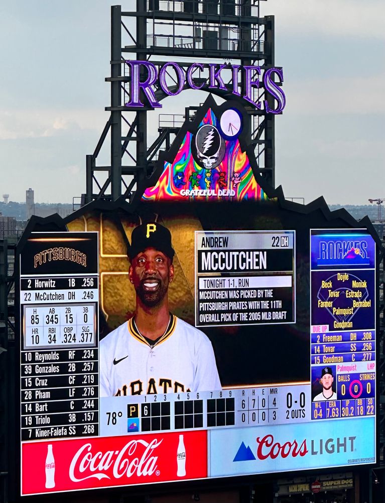 Picture of the Coor’s Field scoreboard. Andrew McCutchen is on it, with Grateful Dead coloring on the scoreboard. 