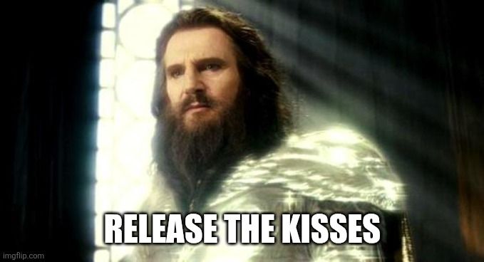 Zeus from the movie Clash of the Titans with the meme caption 'RELEASE THE KISSES'.