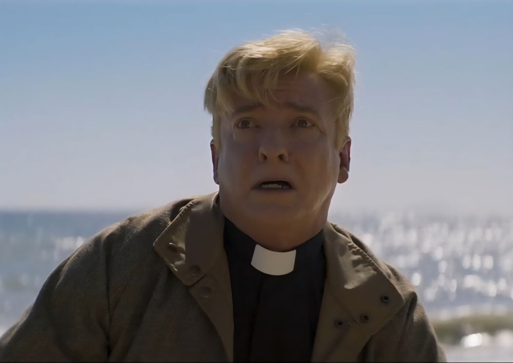 Rhys Darby dressed as a priest looking a bit scared in the 'Love Death & Robots' episode 'Golgatha.'