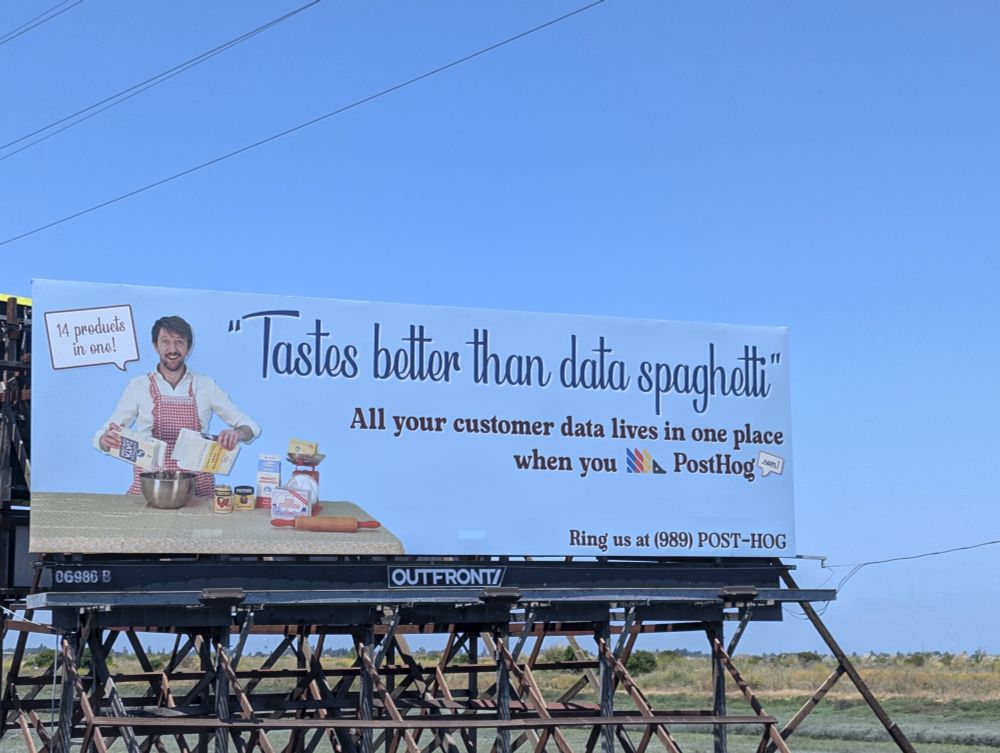 Billboard with a slogan written by somebody unfamiliar with BlueSky: "All your customer data lives in one place when you Post Hog"