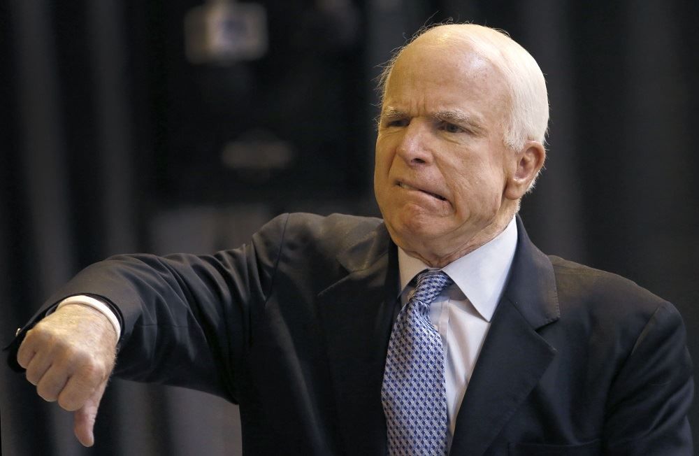 A picture of Senator John McCain with his right thumb turned down. A republican, he was the deciding "no" vote to a Republican effort to overturn the Affordable Care Act.