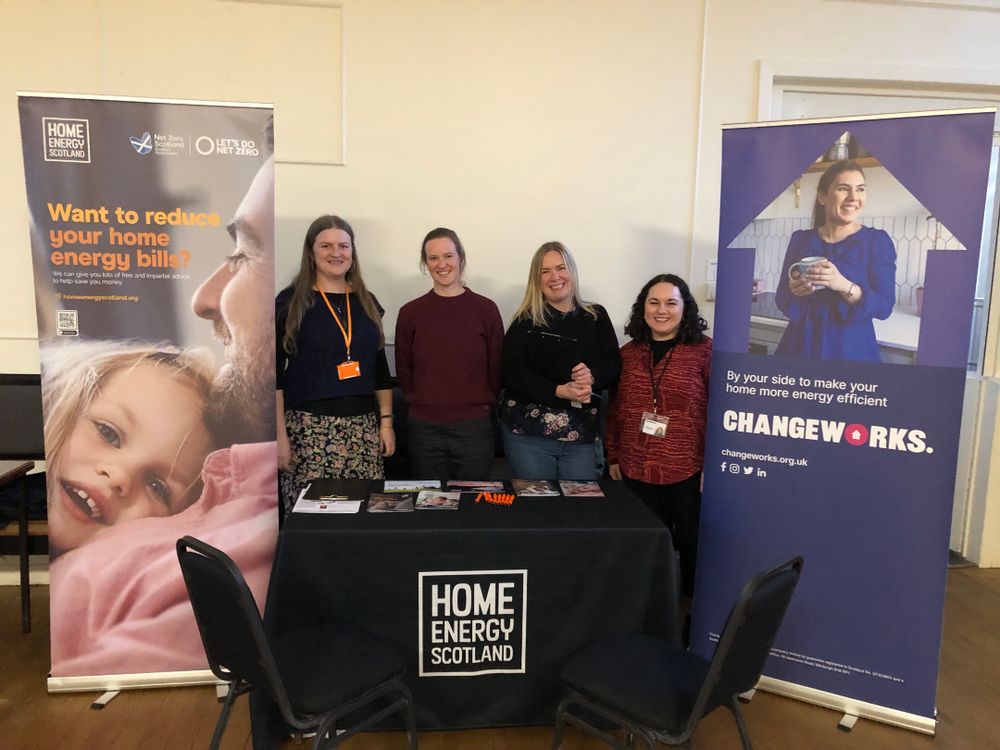 Our colleagues at the event standing behind a stall together.