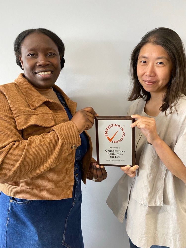 A photo of the new volunteer plaque with Valery Masawi and volunteer Wai Shek