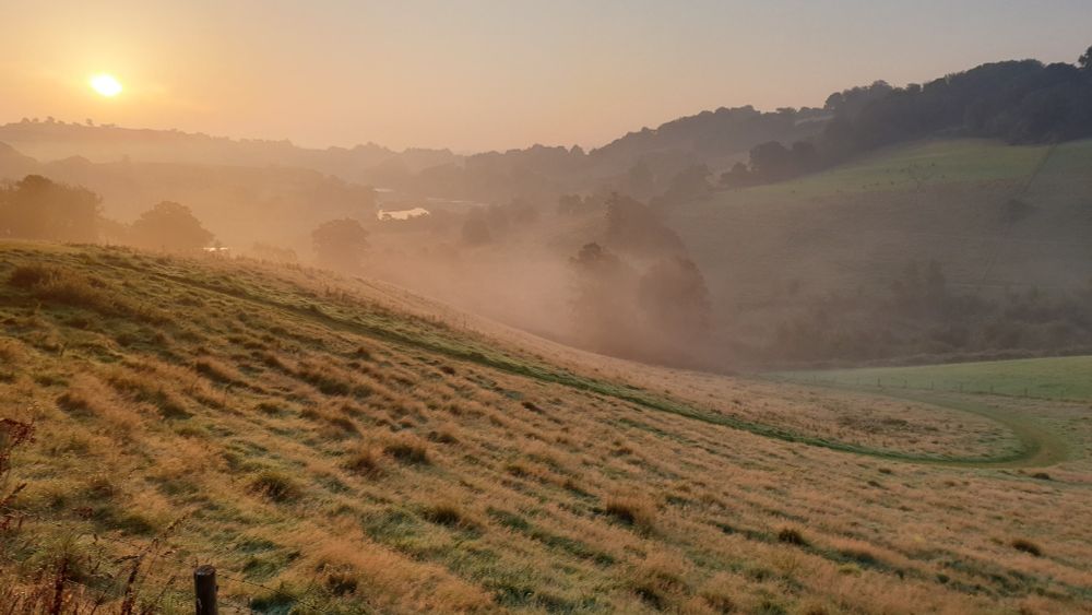 Mist rising from the Dart valley at dawn.