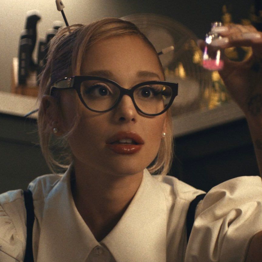 Ariana Grande in "the boy is mine" music video holding a small vile of love potion.