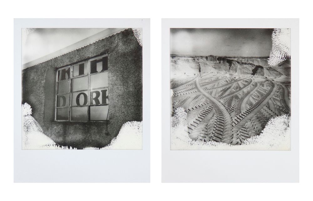 Two b&w polaroid images - left... the writing on the side of a lorry seen through the window of a derelict building, right... vehicle tracks in sand.