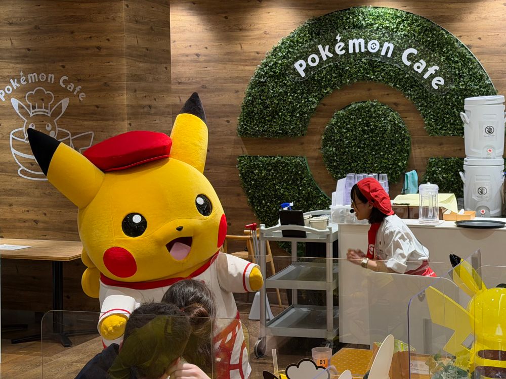 A giant chef Pikachu entertaining patrons at the Pokémon Cafe