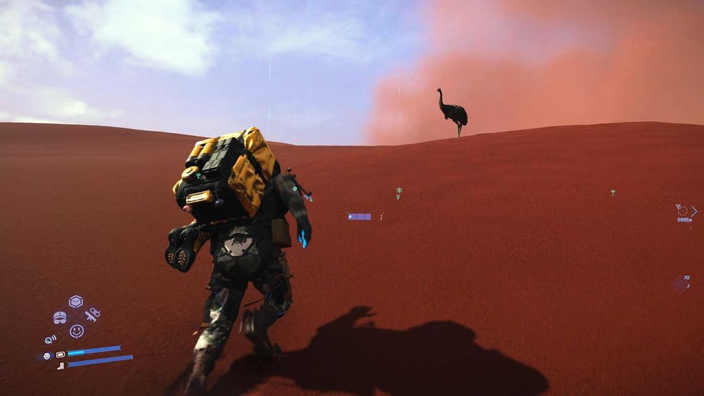 Death Stranding 2: Sam is walking up a sand dune, an emu stands at its peak
