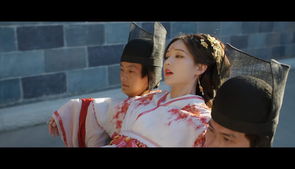 A still from the Chinese drama #ADreamWithinADream showing a girl being carried against her will to attend an event. 