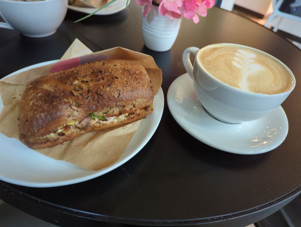 Plate with a Smoked Salmon Ciabatta and a cup of Cappuccino