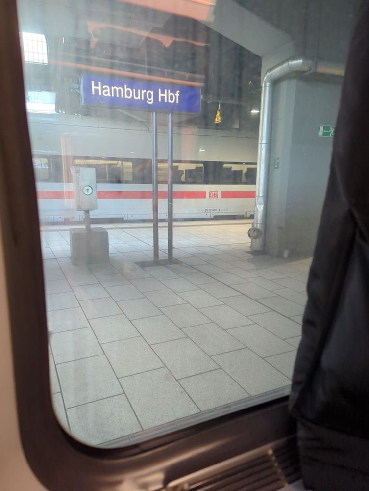 View through the train window to Hamburg Train station with an ICE on the opposite track