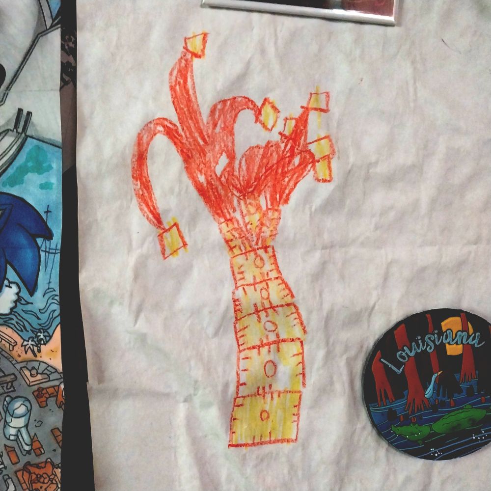 Child's illustration on white paper of a palm-like tree made of Cheez-It crackers drawn in orange and yellow crayon