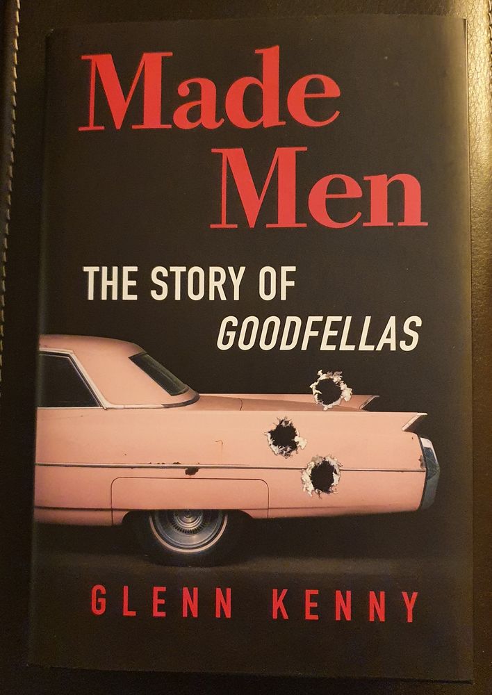 Book cover, Made Men, the story of Goodfellas. By Glenn Kenny.
The rear of a pink caddy is decorated by three bullet holes.