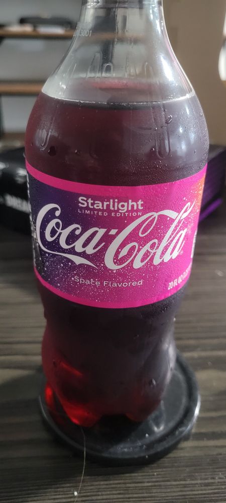 Photo of a limited edition "Starlight" coke bottle sat on a coaster on a coffe table. The "space flavor" claims entices your want to take a sip. It tickles your brain with "yeah..what would that taste like?" or "How did they get that flavor?" Then you're left wondering about Coke being the "Cookie Clicker" of soda makers. What methods does it employ to capture those flavors? Alchemy? Aliens? Actual magic?
So many mysteries to unravel. 