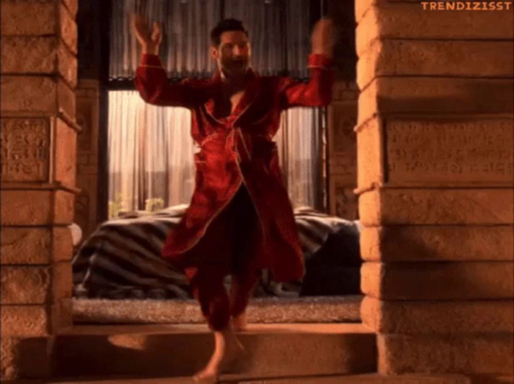 a man in a red robe is dancing in front of a window