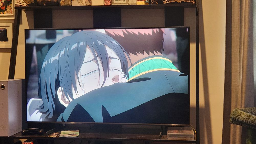 A TV paused on season 2, episode 16 of Wind Breaker anime where two young men are hugging post high school delinquent brawl battle