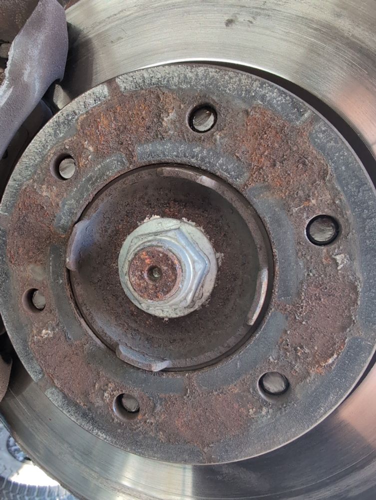 six lug hub with brake rotor still attached, but wheel lugs all sheared off at the same depth