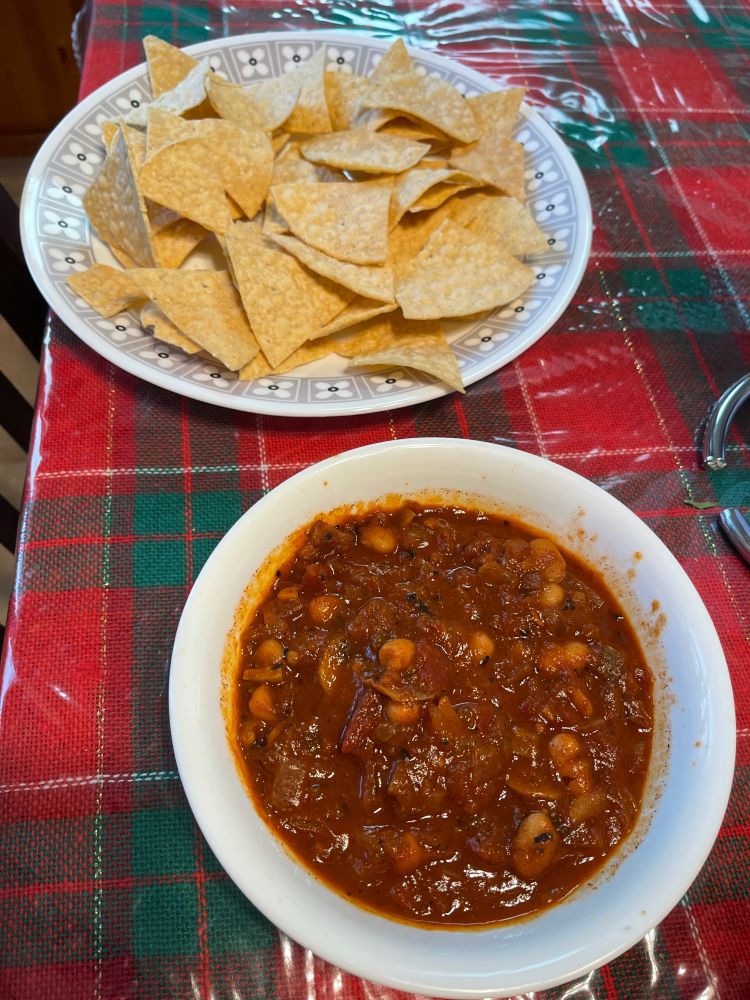 A bowl of chili with visible beans in it),