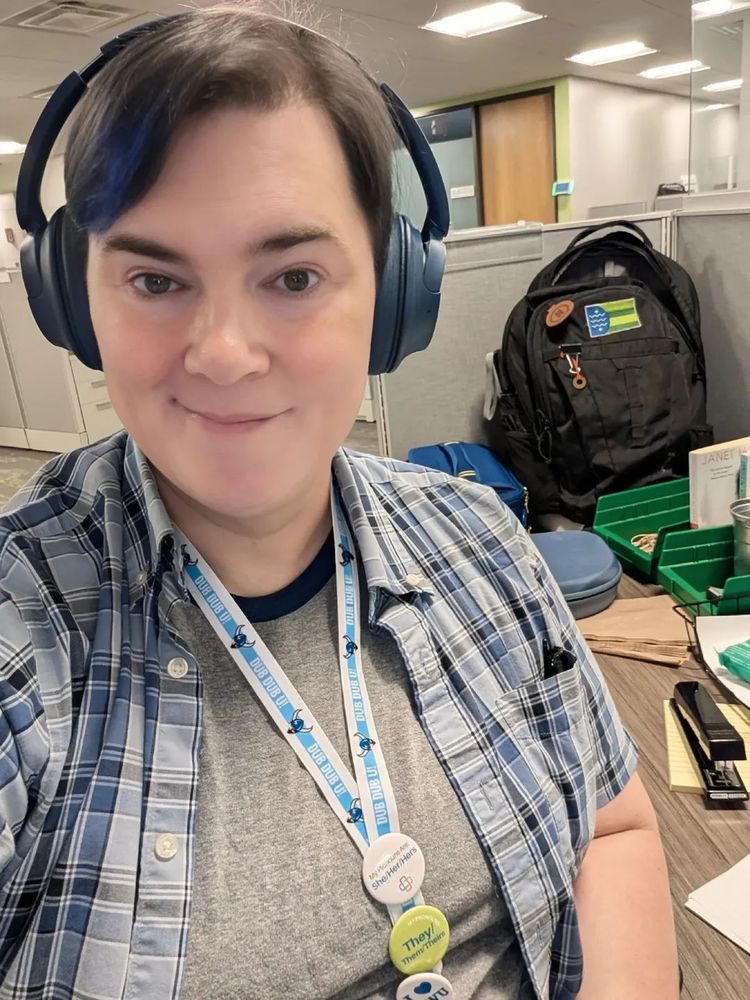 A selfie of Mona at her work cubicle at the start of her in-office day.