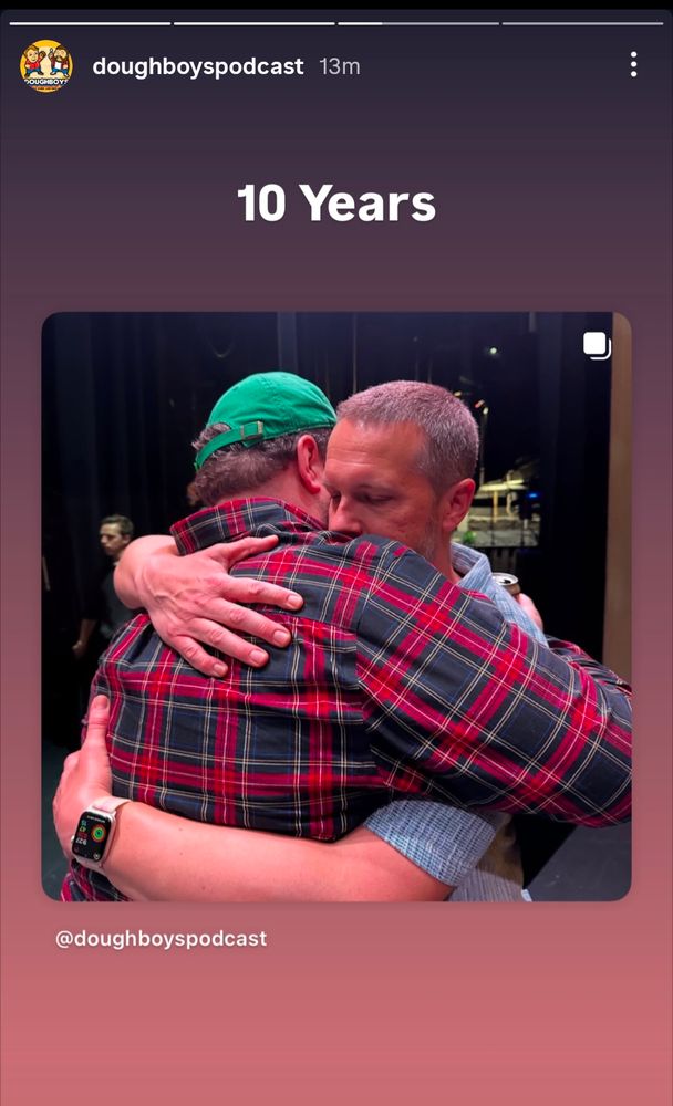 An IG Story from the Doughboys podcast account featuring Nick Wiger and Mike Mitchell hugging with the caption "10 Years"
