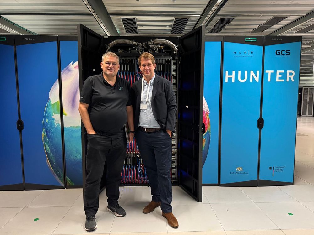 Photo of Michael Resch and Michael Bloss in front of the Hunter supercomputer at HLRS