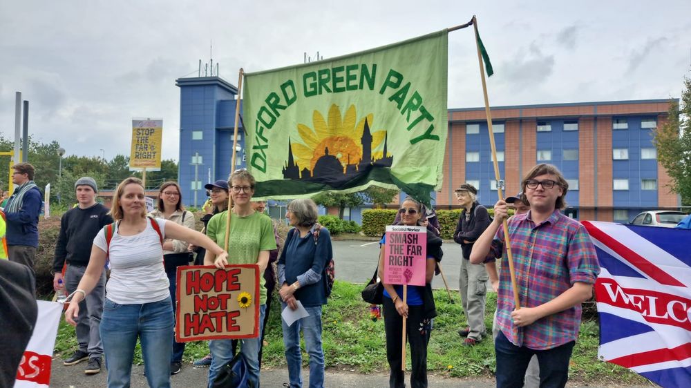 Oxford Green party banner with people gathered around