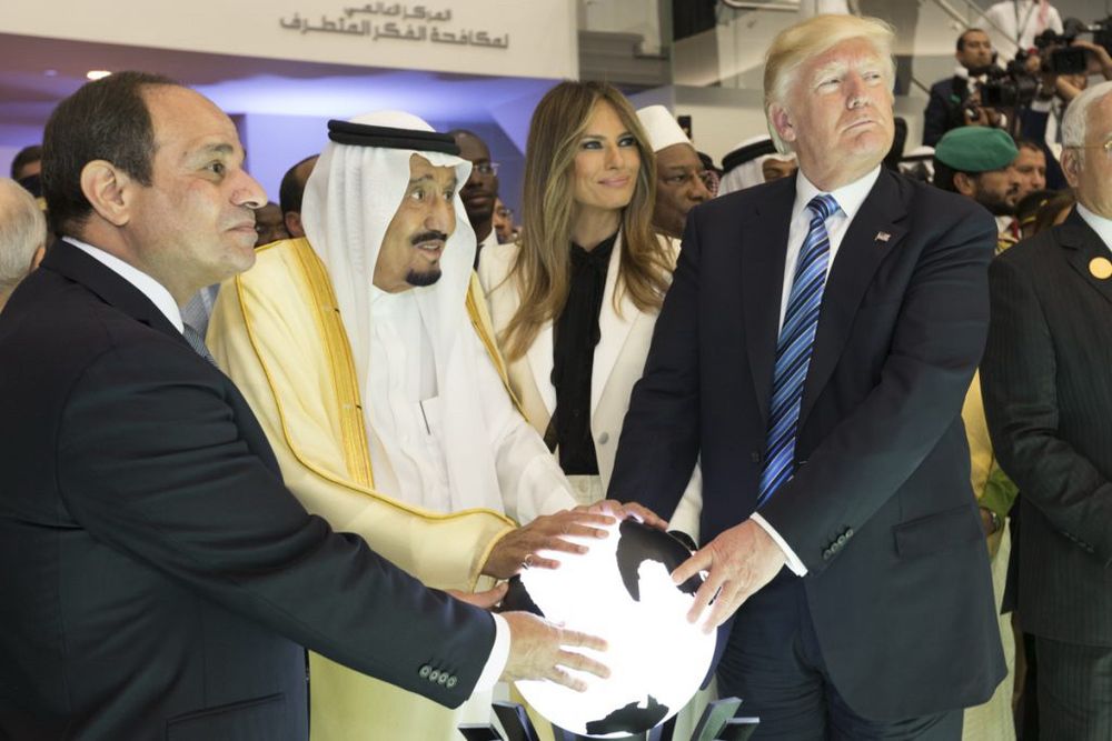 King Salman of Saudi Arabia, Egyptian President Abdel Fattah al-Sisi, and Donald Trump,  pictured planning which parts of the world they will destroy with a large glowing globe.

Melania Trump in the background smiling at someone who isn’t Donald Trump.