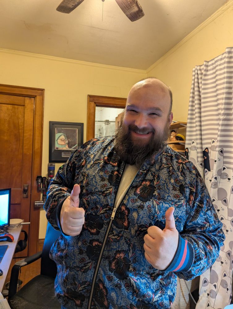 Guy with a beard wearing a very cool jacket.