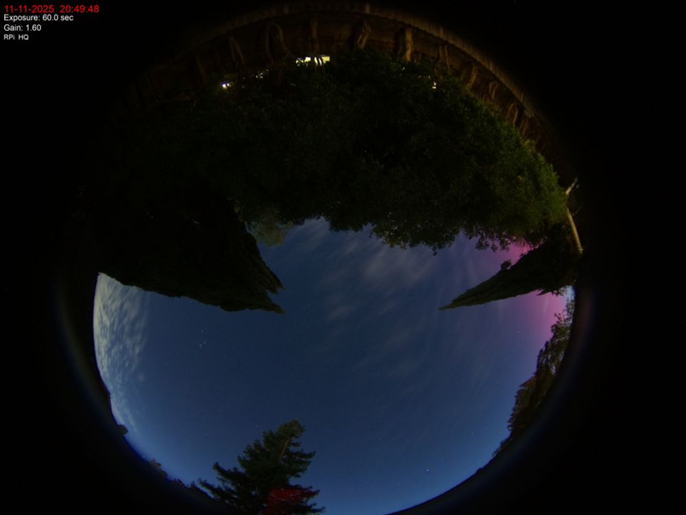 Skycam image showing the evening sky with a pink hue on the right side, which corresponds to the northern direction.