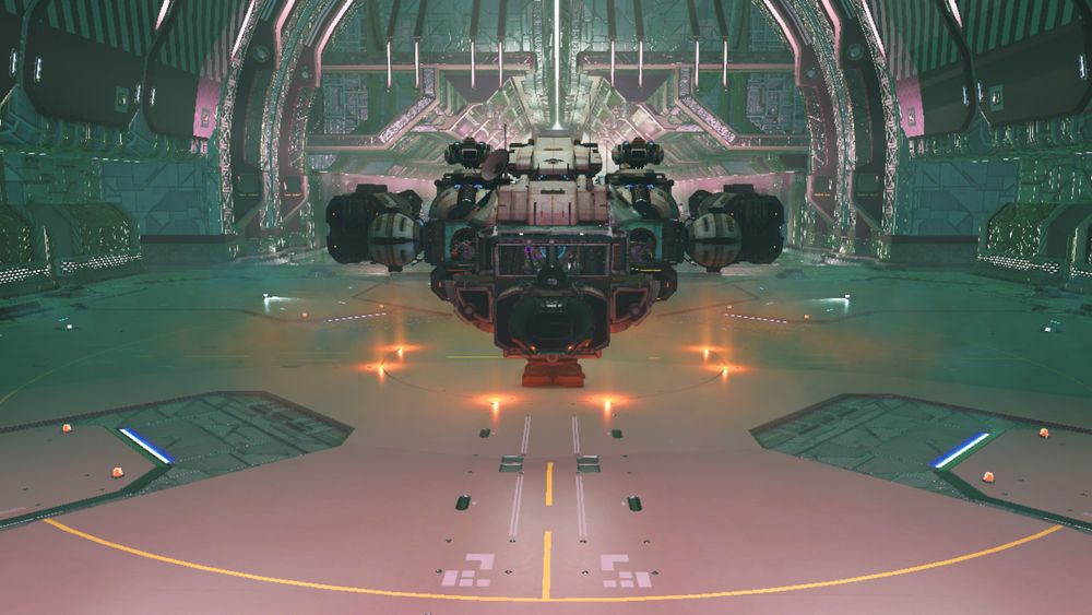 A spaceship from No Man's Sky sits in a space station, as though on a showroom floor. It is framed at a head-on angle. It is mostly black and white, with orange lights surrounding it. The outside appears weathered and slightly rusted, as though made of scrap parts.