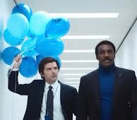 Mark from Severance carries blue balloons walking next to Mr Milchik from Severance 