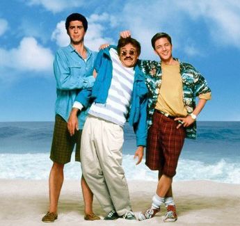 Two young white guys holding up a third clearly dead old white guy from the movie Weekend at Bernies 