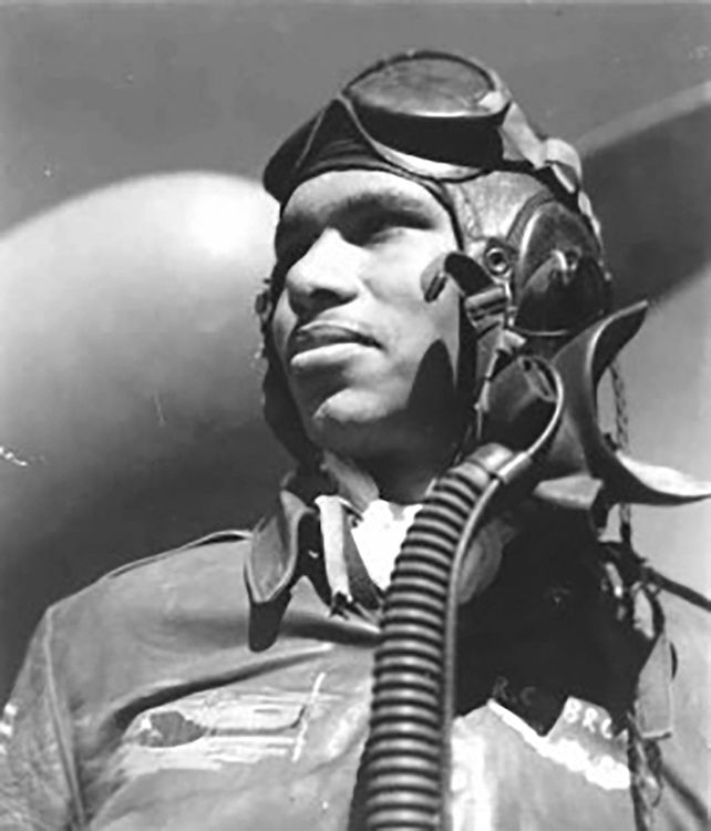 Photograph of Tuskegee Airman Roscoe Brown in flight gear and helmet, looking to the side.
