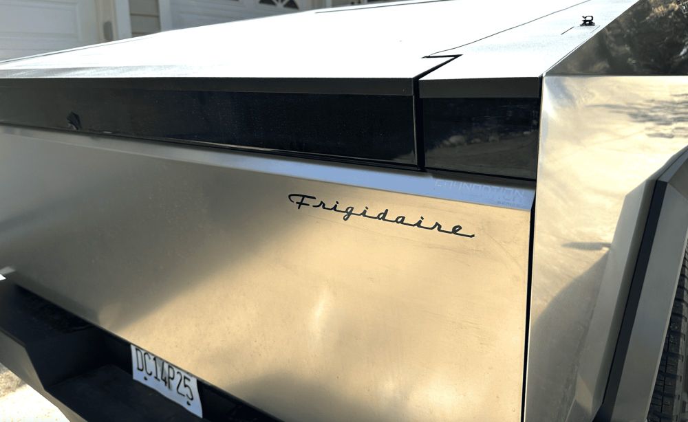A Tesla CyberTruck tailgate with a Frigidaire sticker applied to it.