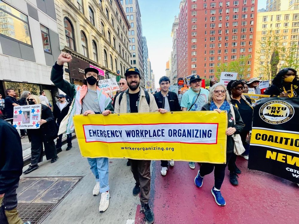 NYC EWOC workers holding a banner reading "Emergency Workplace Organizing" in a march