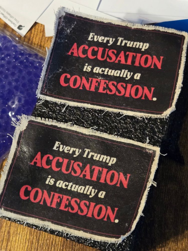 Two distressed morale patches; they feature a simple black background with a red border framing the text "Every Trump ACCUSATION is actually a CONFESSION." "Accusation" and "Confession" are highlighted in red.