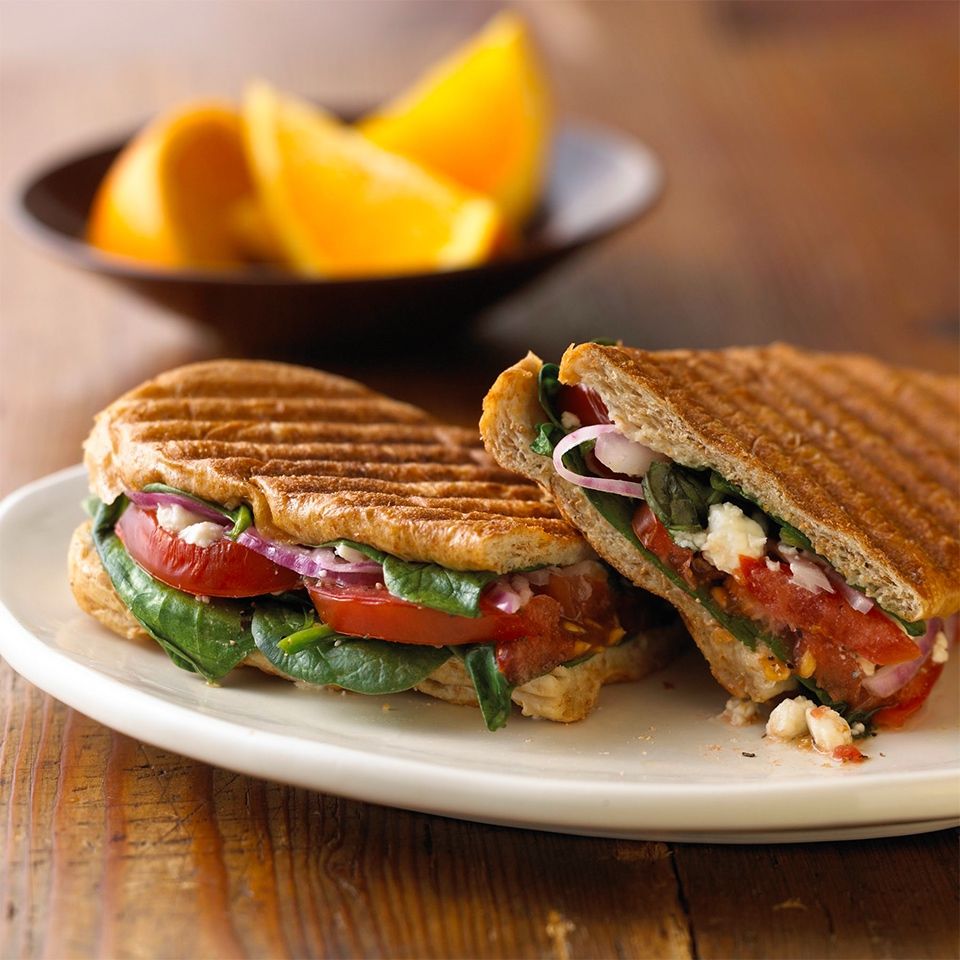 A photograph of two large paninis on a plate. Pretend there’s only one of these plz… ._.
