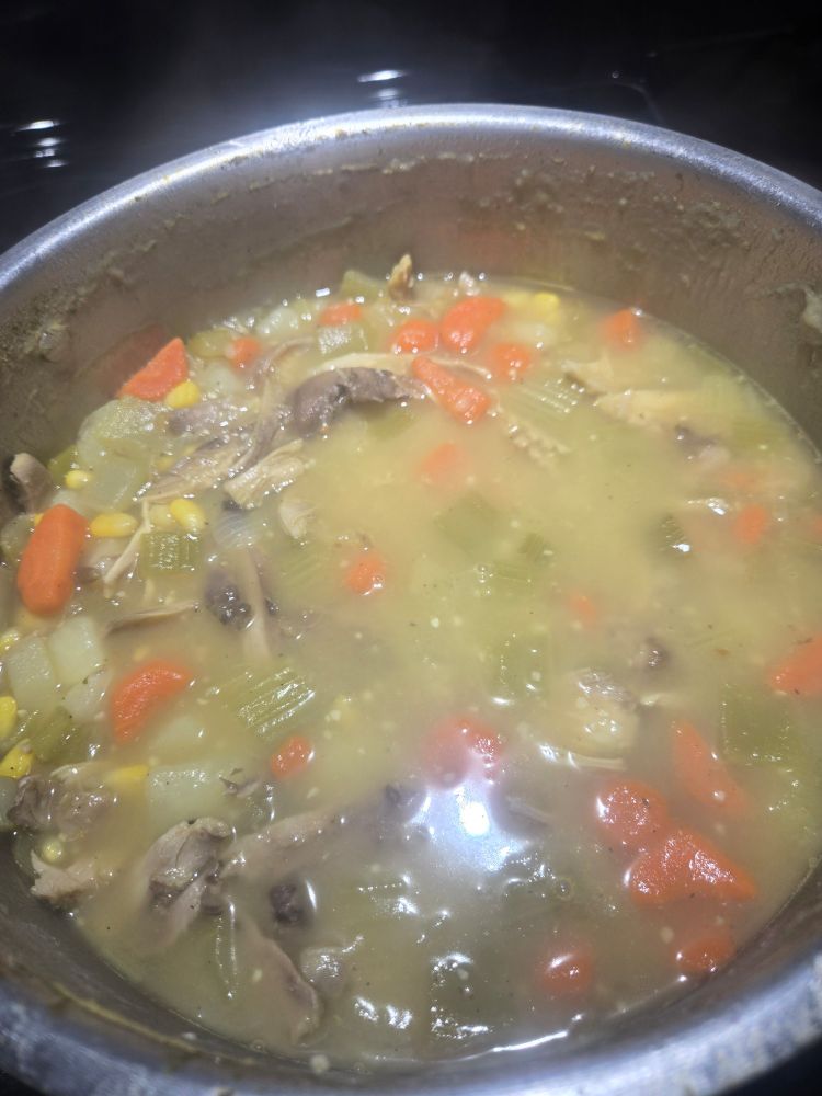 A bot full of veggies and rabbit meat