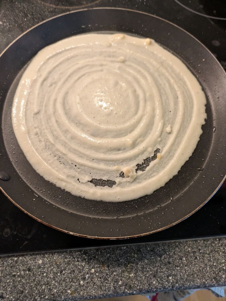 Indian pan cake batter in a pan. 